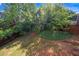 Lush backyard with mature trees and foliage offering a serene outdoor space at 213 Roseman Way, Woodstock, GA 30188