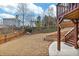 Backyard featuring a wood fence, retaining walls, and mature trees at 213 Roseman Way, Woodstock, GA 30188