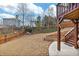 Expansive backyard with a well-manicured lawn, wooden fence, and a staircase, perfect for outdoor activities at 213 Roseman Way, Woodstock, GA 30188