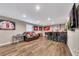 Basement living area with a bar, TV, and comfortable seating, perfect for relaxation and entertainment at 213 Roseman Way, Woodstock, GA 30188
