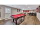 Finished basement boasts a pool table, bar, and seating area for entertaining and leisure at 213 Roseman Way, Woodstock, GA 30188
