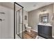 Modern bathroom features tile shower, glass doors, vanity, and decor at 213 Roseman Way, Woodstock, GA 30188
