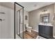 Modern bathroom with tiled walk-in shower, sleek vanity, modern fixtures, and wood-look flooring at 213 Roseman Way, Woodstock, GA 30188