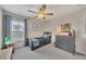 Bedroom features a ceiling fan, window with blinds, and decor at 213 Roseman Way, Woodstock, GA 30188