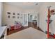 Playroom with a large window and a view into the foyer through white framed glass doors at 213 Roseman Way, Woodstock, GA 30188