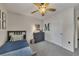 Bedroom features a ceiling fan, window with blinds, and decor at 213 Roseman Way, Woodstock, GA 30188