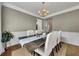 Formal dining room with wainscoting, hardwood floors, and seating for six at 213 Roseman Way, Woodstock, GA 30188