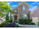 Traditional two-story brick home with a well-manicured lawn, shutters, and an attached garage at 213 Roseman Way, Woodstock, GA 30188