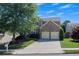 Two-story home with a two-car garage, surrounded by green lawn and mature trees providing shade at 213 Roseman Way, Woodstock, GA 30188