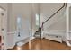 Bright foyer featuring hardwood floors, a staircase with white railings, and a two-story ceiling at 213 Roseman Way, Woodstock, GA 30188