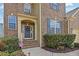 Inviting entrance to a brick home with manicured shrubs and an American flag creating a welcoming atmosphere at 213 Roseman Way, Woodstock, GA 30188