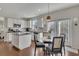Modern kitchen with white cabinets, granite countertops, stainless steel appliances, and an island at 213 Roseman Way, Woodstock, GA 30188