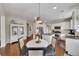 Bright kitchen boasts stainless appliances, granite countertops, a center island, and a cozy breakfast nook at 213 Roseman Way, Woodstock, GA 30188