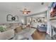 Open living room area with a view to the kitchen, comfortable seating, and a fireplace at 213 Roseman Way, Woodstock, GA 30188
