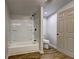 Bathroom with a white tub and shower combination, toilet, and wood-look flooring at 350 White Birch Dr, Covington, GA 30016