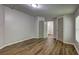 A simple bedroom design with wood-look flooring and a doorway leading to an en-suite bath or walk-in closet at 350 White Birch Dr, Covington, GA 30016