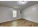 Bright bedroom with neutral gray walls, wood-look flooring and a single window at 350 White Birch Dr, Covington, GA 30016