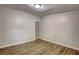 Bedroom featuring modern gray walls, wood-look flooring, and a single window at 350 White Birch Dr, Covington, GA 30016