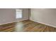 Bedroom features wood-look flooring, window for natural light, and a neutral gray wall color at 350 White Birch Dr, Covington, GA 30016