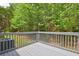 Spacious deck with gray-painted wood, offering serene views of lush trees and greenery at 350 White Birch Dr, Covington, GA 30016