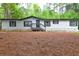 Charming single story home with light siding, dark shutters and trim, and inviting front porch at 350 White Birch Dr, Covington, GA 30016