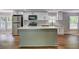 Beautiful updated kitchen with a stainless refrigerator, kitchen island, and white cabinets and backsplash at 350 White Birch Dr, Covington, GA 30016