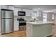 Well-lit kitchen with stainless steel appliances, including a refrigerator, microwave, and oven, and a convenient center island at 350 White Birch Dr, Covington, GA 30016