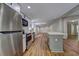 Open concept kitchen with stainless steel appliances, kitchen island, and seamless transition to the living area at 350 White Birch Dr, Covington, GA 30016