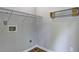 Practical laundry room space with shelving, rod for hanging clothes, and utility connections at 350 White Birch Dr, Covington, GA 30016