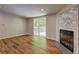 Living room features an elegant fireplace with marble accents and a sliding glass door to the deck at 350 White Birch Dr, Covington, GA 30016