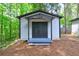 Exterior of a one-story outbuilding with black double door entry and covered porch at 350 White Birch Dr, Covington, GA 30016