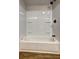 Close-up of the shower and tub combo, with white fixtures and a black shower head at 350 White Birch Dr, Covington, GA 30016