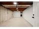 Unfinished basement with concrete walls, exposed pipes, and a white painted wall at 3510 Holliglen Dr, Marietta, GA 30062