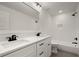 Bathroom featuring dual sinks, quartz countertop, and black fixtures with subway tiled shower at 3510 Holliglen Dr, Marietta, GA 30062