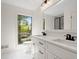 Bright bathroom featuring double sinks, new vanity, and a large window at 3510 Holliglen Dr, Marietta, GA 30062