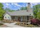 Community clubhouse featuring a covered porch, stone chimney, and well-maintained landscaping at 3510 Holliglen Dr, Marietta, GA 30062