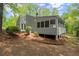 Home exterior with screen porch and wooded backyard at 3510 Holliglen Dr, Marietta, GA 30062