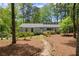 Charming home with a landscaped front yard, mature trees and walkway leading to the front door at 3510 Holliglen Dr, Marietta, GA 30062