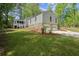 Charming home featuring a stone foundation, attached two-car garage, and manicured lawn at 3510 Holliglen Dr, Marietta, GA 30062