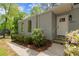 Front exterior featuring fresh landscaping, gray siding, a bright white door and stone steps at 3510 Holliglen Dr, Marietta, GA 30062