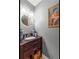 Charming powder room with wood vanity, vessel sink and framed art at 1261 Lavista Ne Rd # J-4, Atlanta, GA 30324