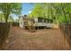 Backyard with a home featuring stairs to a screened-in patio, and a full fence at 2962 Invermere Woods Ct, Lithonia, GA 30038