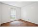 Empty bedroom with neutral colored walls and flooring, and a white-trimmed window at 2962 Invermere Woods Ct, Lithonia, GA 30038