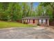 Charming brick home with lush lawn and paved driveway at 2962 Invermere Woods Ct, Lithonia, GA 30038