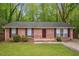 Charming single-story brick home featuring a well-maintained lawn and inviting curb appeal at 2962 Invermere Woods Ct, Lithonia, GA 30038