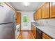 Functional kitchen featuring wood cabinets, stainless steel refrigerator and laminate countertops at 2962 Invermere Woods Ct, Lithonia, GA 30038