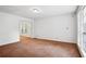 Spacious living room area with large windows and neutral colored carpeting at 2962 Invermere Woods Ct, Lithonia, GA 30038