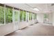 Bright sunroom enclosed with glass windows and doors offering ample natural light and backyard views at 2962 Invermere Woods Ct, Lithonia, GA 30038