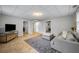 This finished basement features tile floor, a gray sofa with pillows and walkout to backyard at 4350 Oakdale Vinings Se Cir, Smyrna, GA 30080
