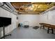 Unfinished basement space with grey floor, exposed ceiling, and fitness equipment at 4350 Oakdale Vinings Se Cir, Smyrna, GA 30080